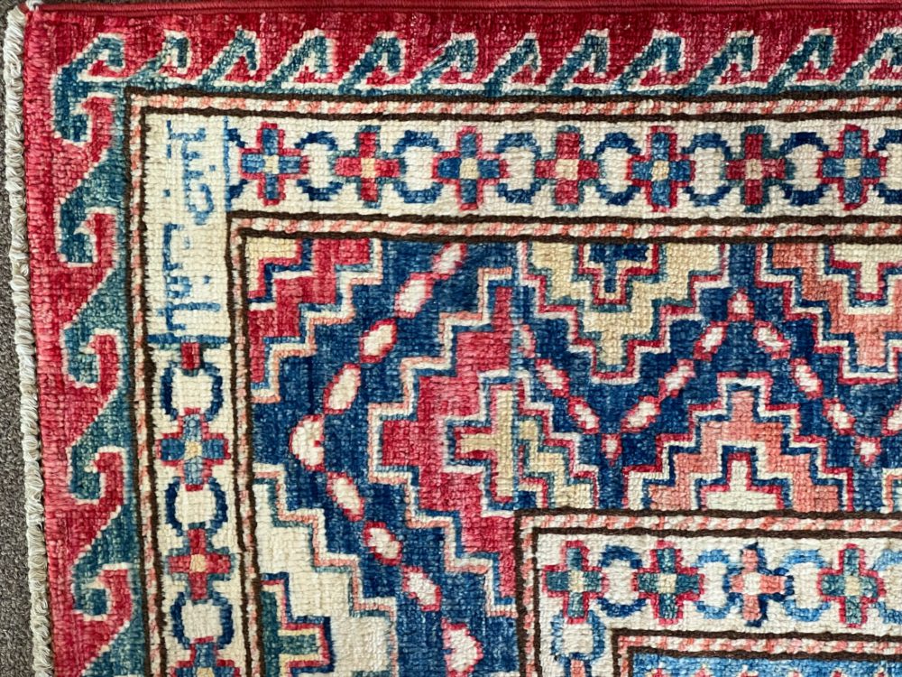 06491 Super Kazak Afghan Red Blue Natural 7-10×9-9 | Manoukian Rugs™ corner