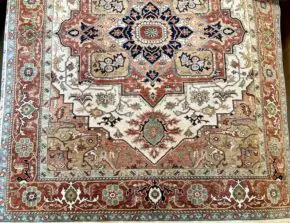 This hand knotted Indo Serapi rug lends a traditional feel to your favorite room. It carries bold geo-floral design elements along with a pleasing balance of soft colors.